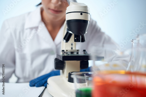 scientist looking at microscope