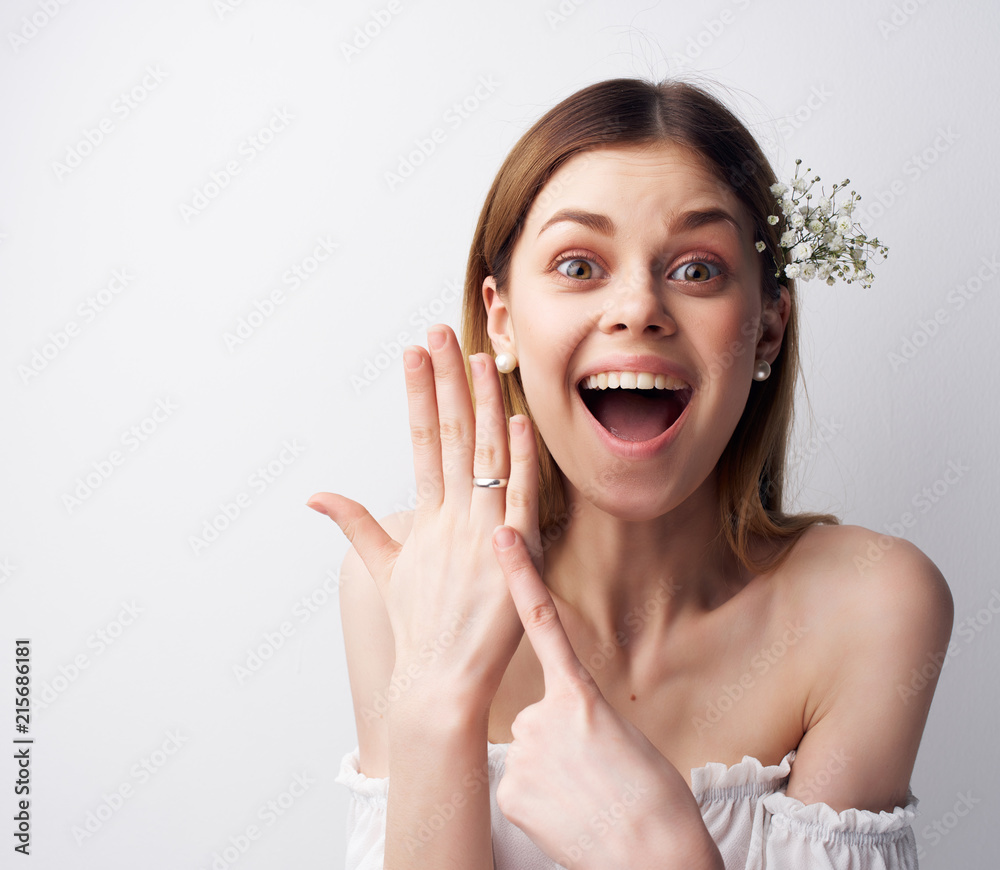 joyful woman with a flower in her hair ring on her hand joyful woman with a flower in her hair ring on her hand