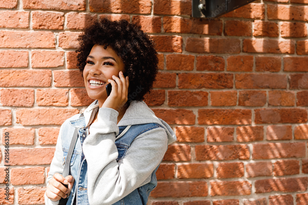 Portrait of a beautiful smiling woman talking on cell phone outdoors Portrait of a beautiful smiling woman talking on cell phone outdoors