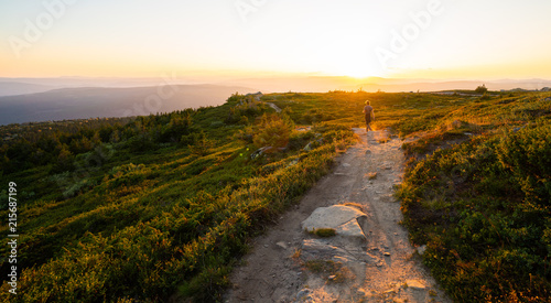 Man hiking at sundown on the Hafjelltoppen in Norway