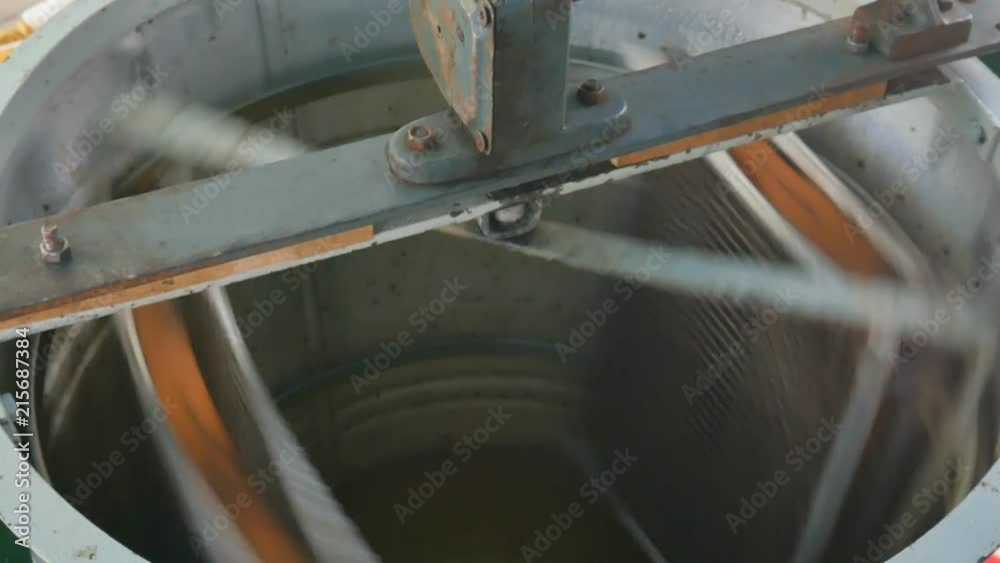 Manual centrifuge device that Spin the Honey from cells. An extractor is a device that spins the honey from the cells and into a holding tank Manual centrifuge device that Spin the Honey from cells. An extractor is a device that spins the honey from the cells and into a holding tank