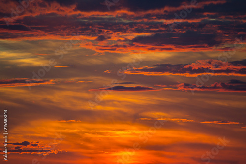 dramatic bright red orange sky with clouds at sunset © alexnikit