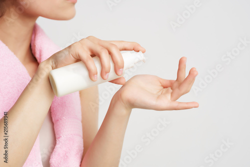 woman with towel body care cream