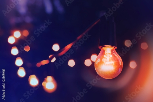 Lights hang overhead on a clear summer night	