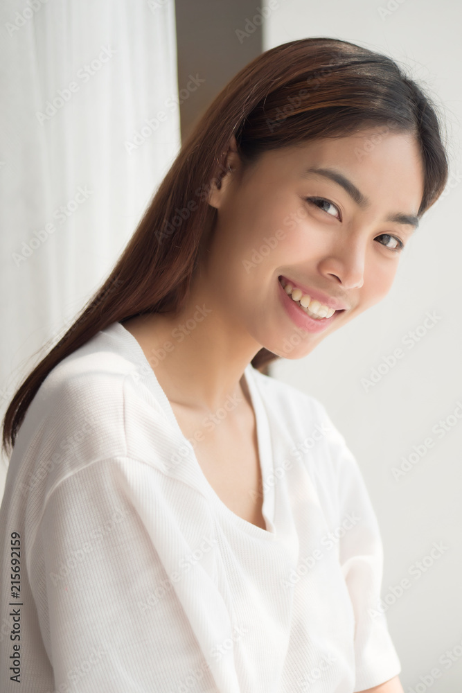 happy smiling girl; portrait of positive relaxed happy smiling asian woman smiles in indoor home environment; young adult asian persian woman or asian middle east woman model happy smiling girl; portrait of positive relaxed happy smiling asian woman smiles in indoor home environment; young adult asian persian woman or asian middle east woman model