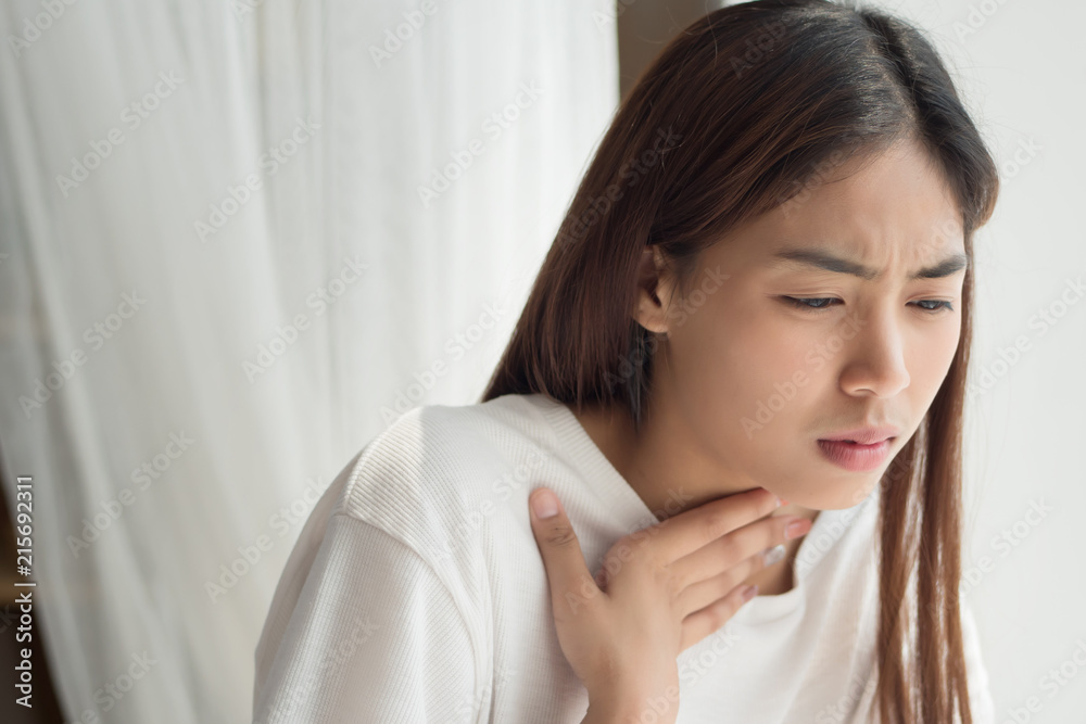 sick woman with sore throat; portrait of woman suffering from cold, flu, sickness with sore throat inflammation; woman health care, body care, sickness, pain concept; asian young adult woman model sick woman with sore throat; portrait of woman suffering from cold, flu, sickness with sore throat inflammation; woman health care, body care, sickness, pain concept; asian young adult woman model