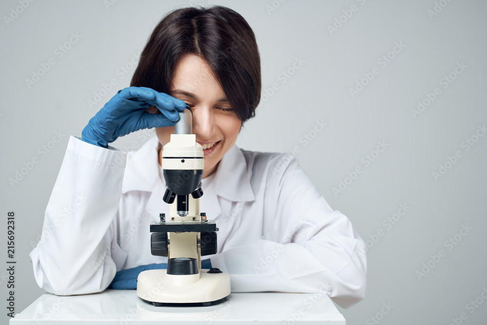 laboratory technician looking through a microscope science laboratory technician looking through a microscope science