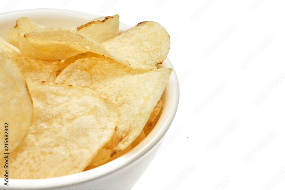 Delicious golden potato chips in a white bowl isolated on white background. Delicious golden potato chips in a white bowl isolated on white background.