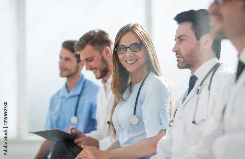 Portrait of female doctor with colleagues at meeting Portrait of female doctor with colleagues at meeting
