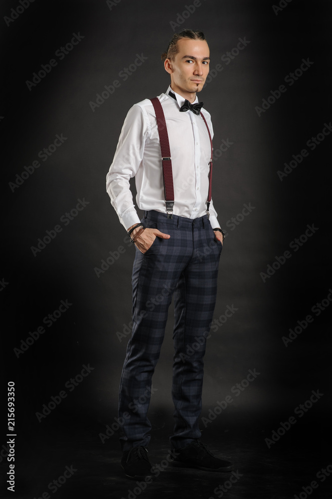Young handsome boy in white shirt with tie and glases, hands in pockets Young handsome boy in white shirt with tie and glases, hands in pockets