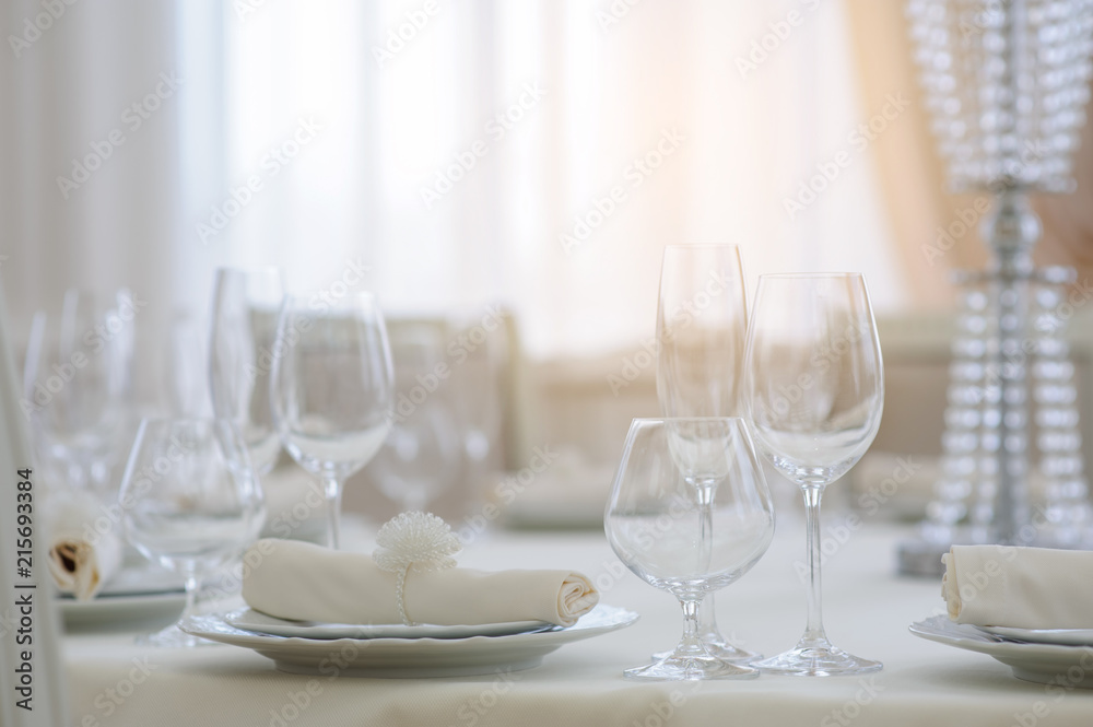The banquet hall with round tables, with cutlery The banquet hall with round tables, with cutlery