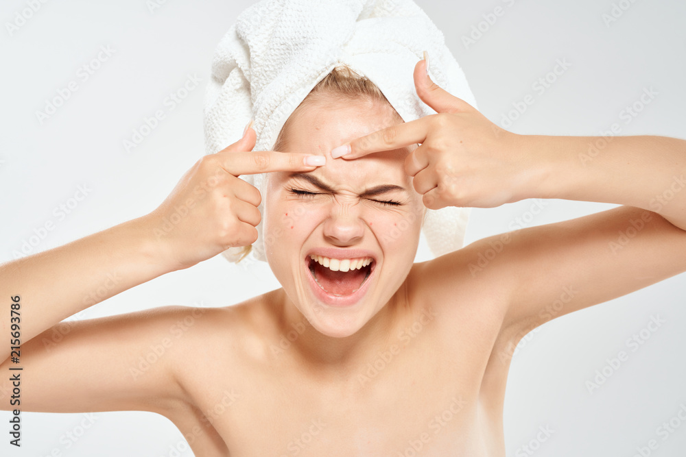 woman squeezes acne on her face woman squeezes acne on her face