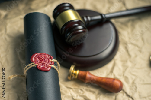 Last will and testament on yellowish paper with wooden judge gavel document is mock-up