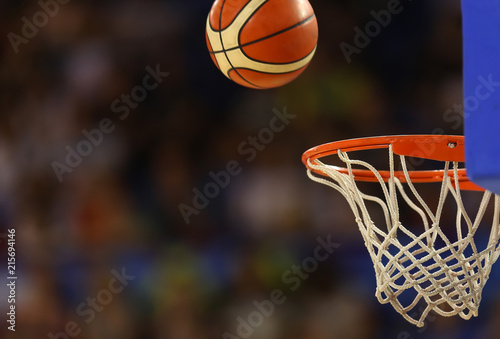 Basketball ball flies towards the basketball hoop on the background of the stands © makedonski2015