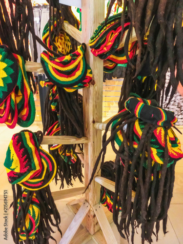 many hats with the colors of the Jamaican flag for sale in the costume shop photo