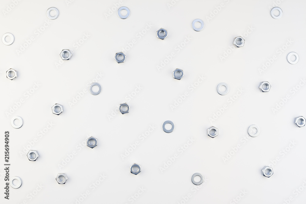Flat lay of metal nuts on white background