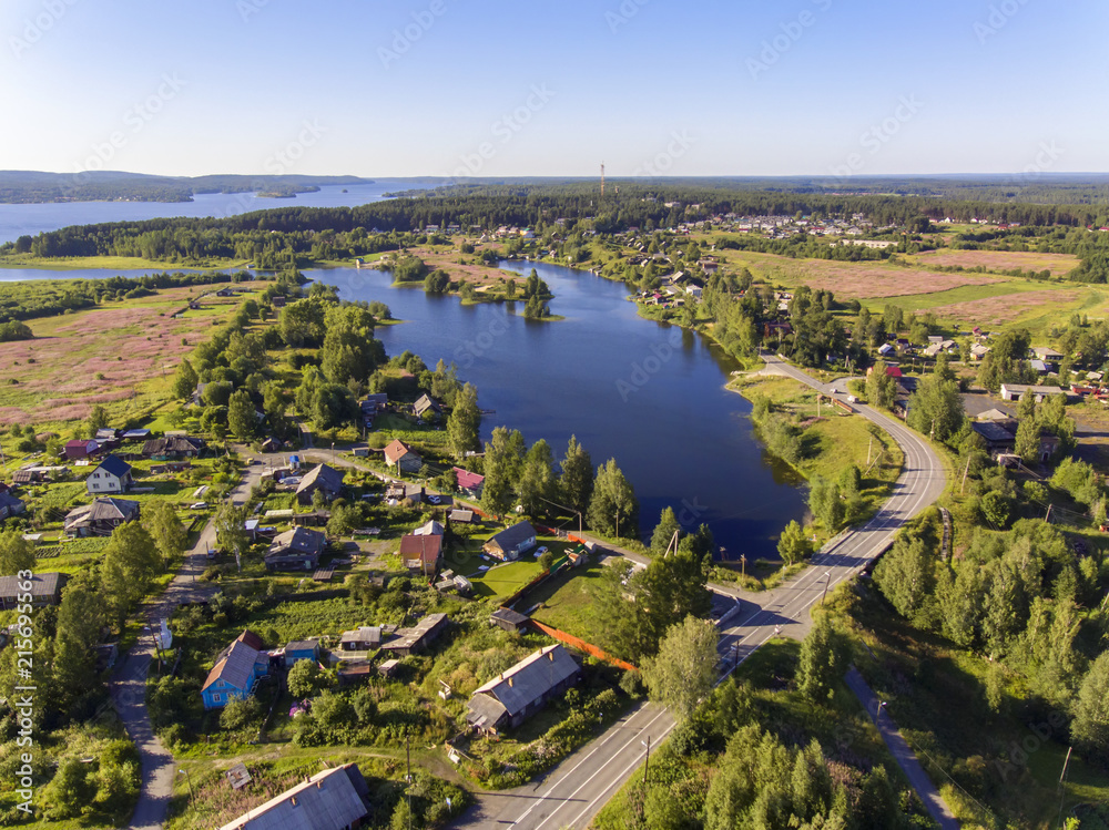 Fototapeta premium Aerial view of beautiful lake and village around it