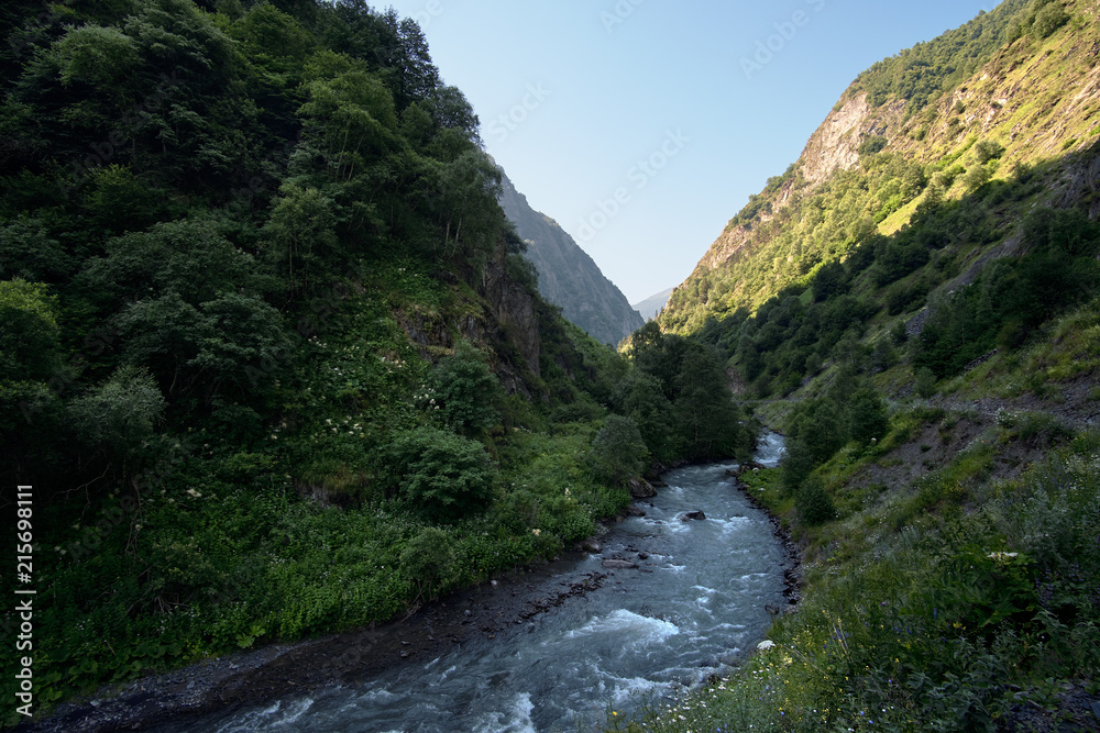Landscape of a mountain valley with a rapid river.