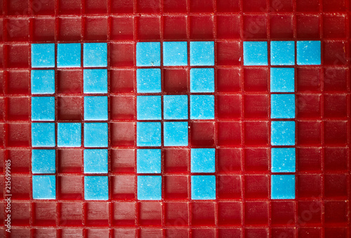 Above view of word ART laid out in blue square tiles over red base