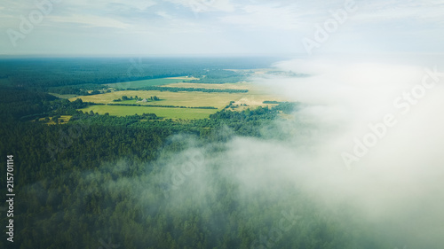 Misty sunrise over countryside path Aerial view Latvia