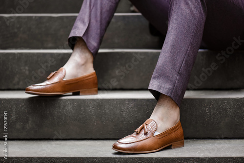 Hipster man wear fashion shoes tassel loafer.On old  floor. Stylish men shoes concept.