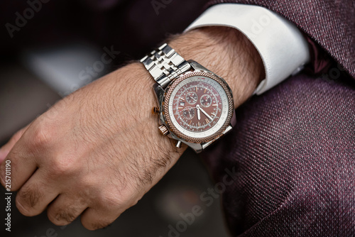Obraz na plátne Wrist watch in a business suit. close up