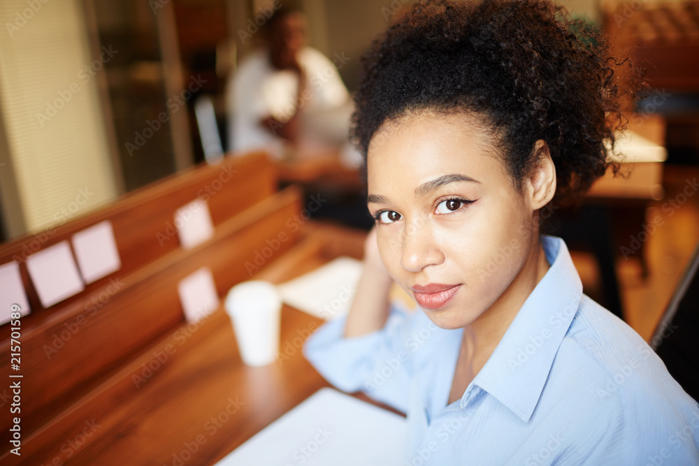 Portrait of African young woman working at desk at office Portrait of African young woman working at desk at office