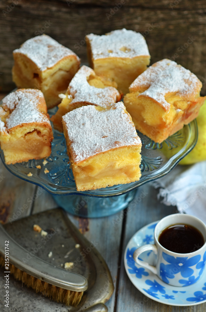Pieces of apple pie on a glass plateau sprinkled with powdered sugar Pieces of apple pie on a glass plateau sprinkled with powdered sugar