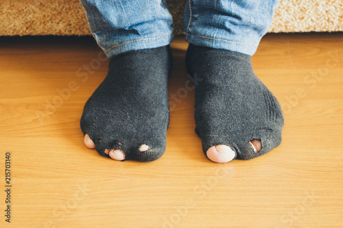 A man is sitting in a leaky socks