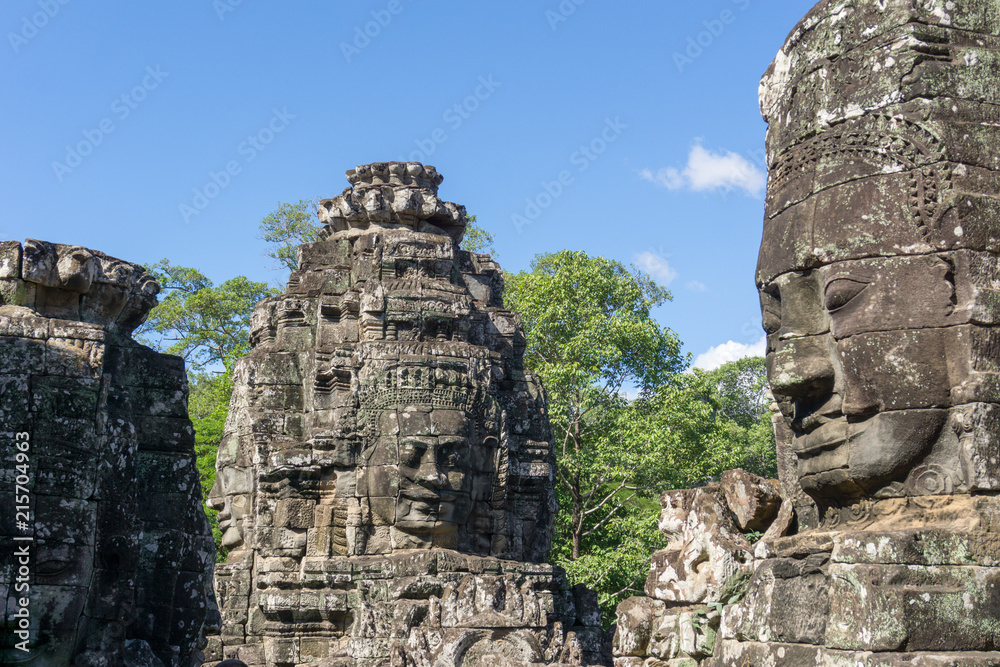 Faces and statues of the Bayon Temple, Angkor Wat, Cambodia