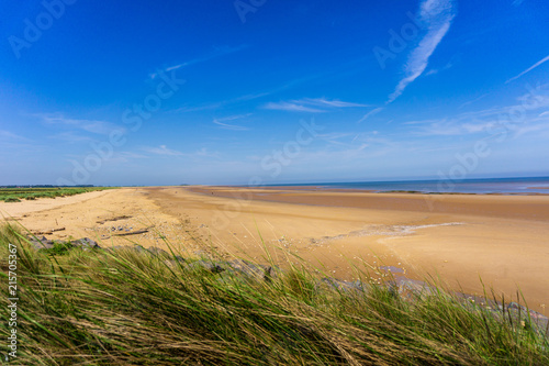 blue sky and a deserted sandy beach to the horizon, Heacham, Norfolk