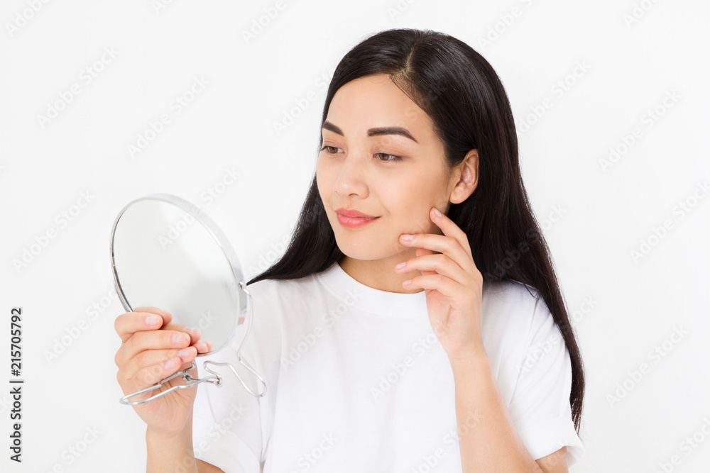 Asian woman looking in mirror. Macro japanese female face isolated on white background. Skin care and beauty spa concept. Anti aging and collagen. Copy space Asian woman looking in mirror. Macro japanese female face isolated on white background. Skin care and beauty spa concept. Anti aging and collagen. Copy space