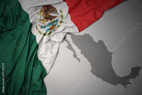 waving colorful national flag and map of mexico. photo