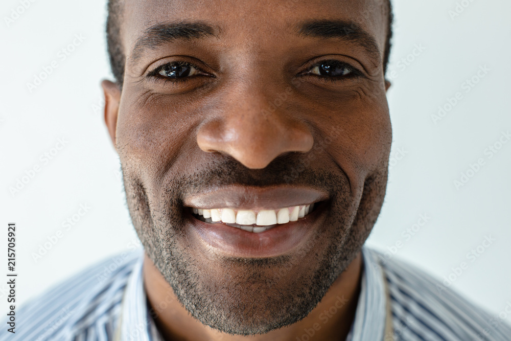 Obraz premium Portrait of joyful afro american man against white background
