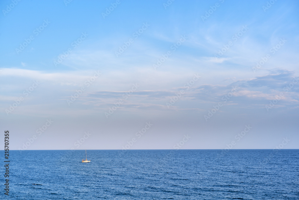 alone yacht sailing in the sea under sky