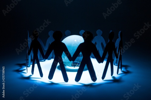 Paper People in a Circle Holding Hands with Glass Globe