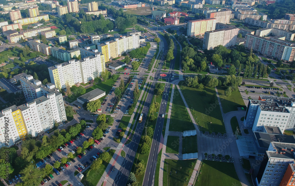 Aerial view on a road with roundabout intersection in city with concrete square buildings