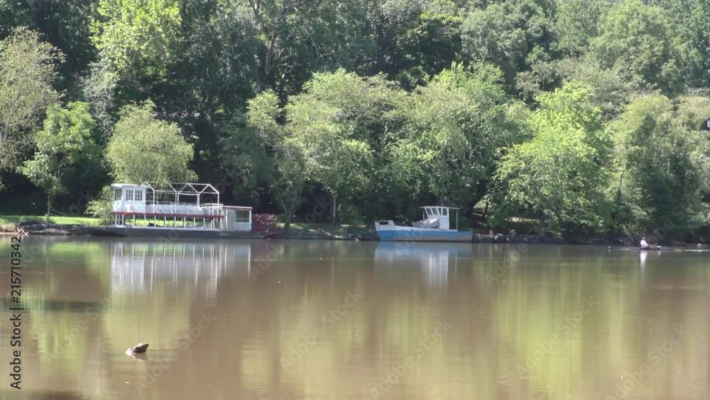 Georgia, Riverside Park, A view of two boats on the Chattahoochee River with a man rowing by Georgia, Riverside Park, A view of two boats on the Chattahoochee River with a man rowing by