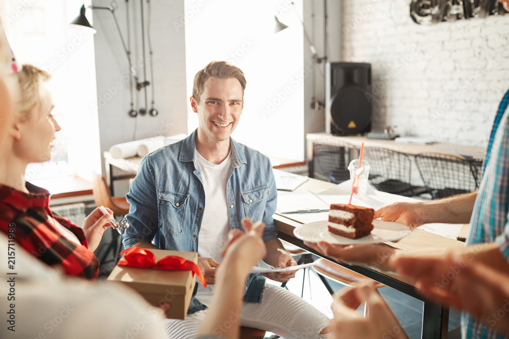 Portrait of creative young people celebrating Birthday in office, focus on handsome man receiving cake and gifts, copy space Portrait of creative young people celebrating Birthday in office, focus on handsome man receiving cake and gifts, copy space
