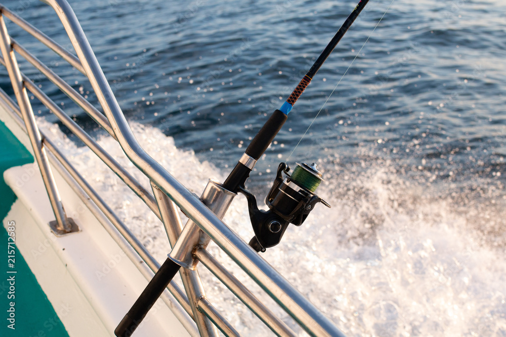 Fishing rod sticking on a yacht in the ocean Fishing rod sticking on a yacht in the ocean