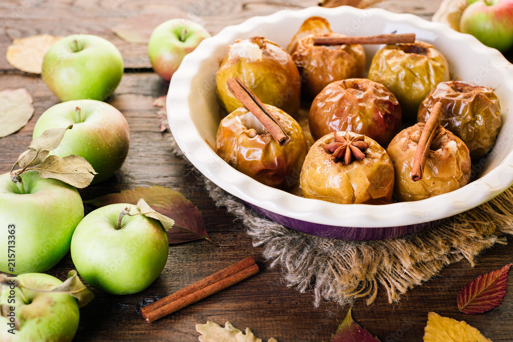 Baked Apples on a Wooden Background Cinnamon Anise and Autumn Leaves Baked Apples on a Wooden Background Cinnamon Anise and Autumn Leaves