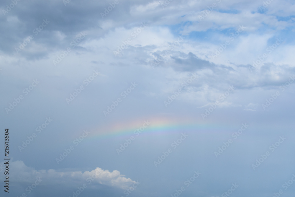 rainbow in the blue sky with clouds after a thunderstorm rainbow in the blue sky with clouds after a thunderstorm