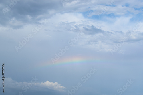 rainbow in the blue sky with clouds after a thunderstorm © Alienka