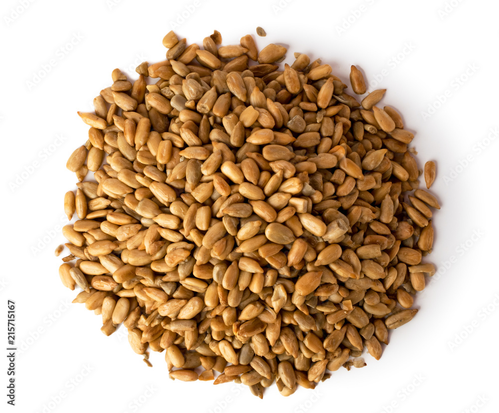 A bunch of peeled roasted sunflower seeds on a white background. The view from the top. A bunch of peeled roasted sunflower seeds on a white background. The view from the top.