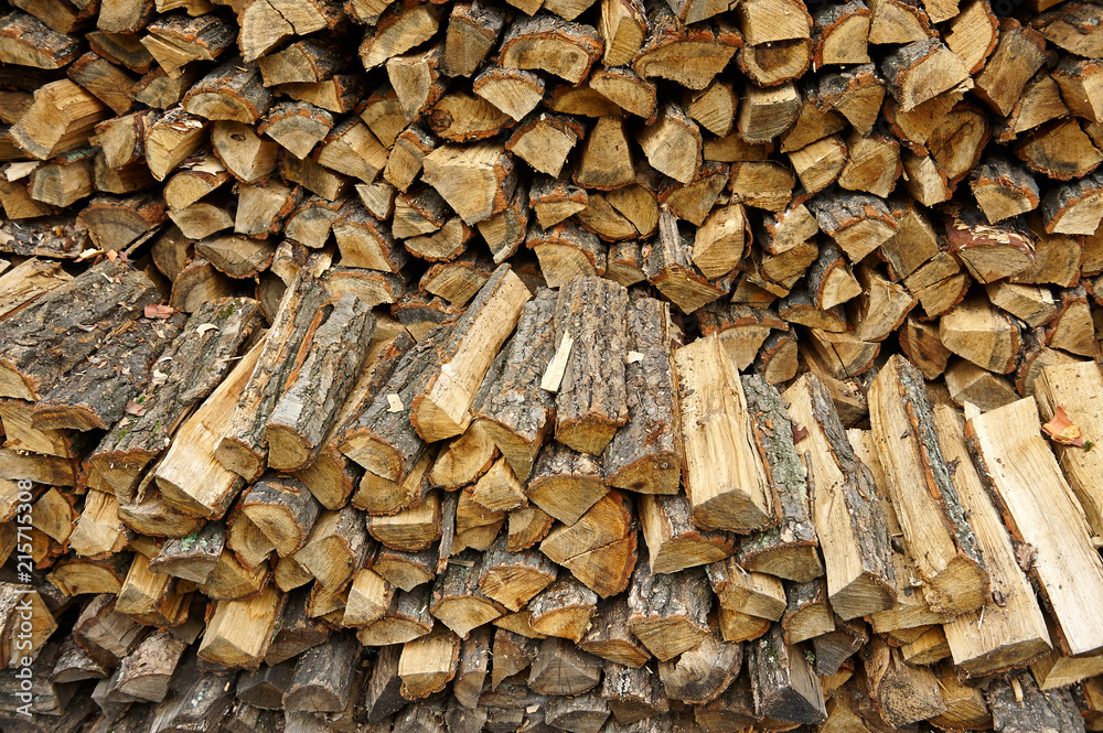 Firewood pile stacked chopped wood trunks for winter heating fireplace Firewood pile stacked chopped wood trunks for winter heating fireplace