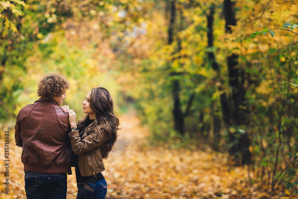 Fototapeta premium Young couple in love hugging in autumn park.