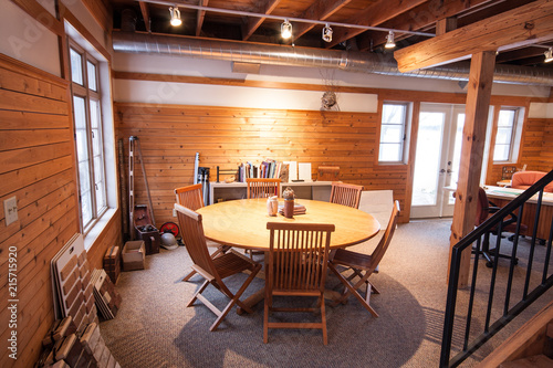 Round conference table in an architectural drafting firm's converted barn