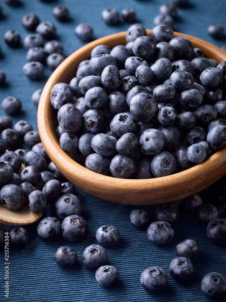 Closeup of fresh blueberries in a wooden plate Closeup of fresh blueberries in a wooden plate