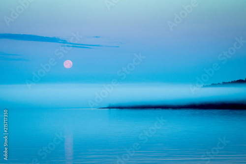 Moonset over harbor