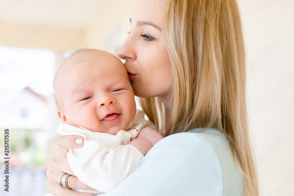 Mother holding a baby in her arms, family portrait. Mother holding a baby in her arms, family portrait.